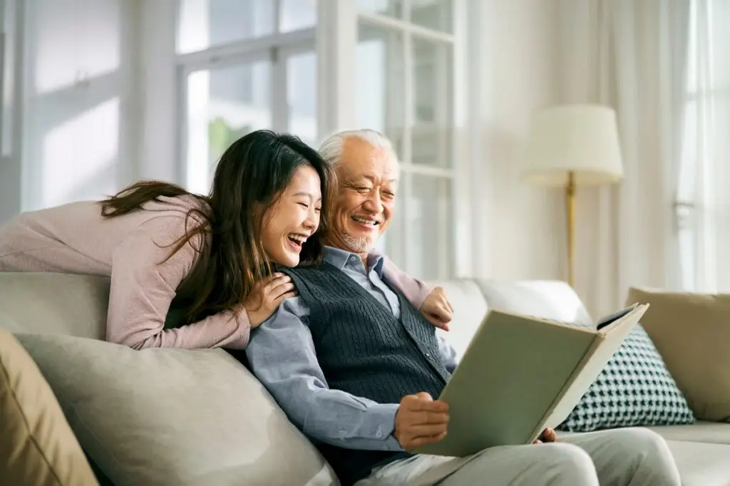 daughter and father looking at a photo album
